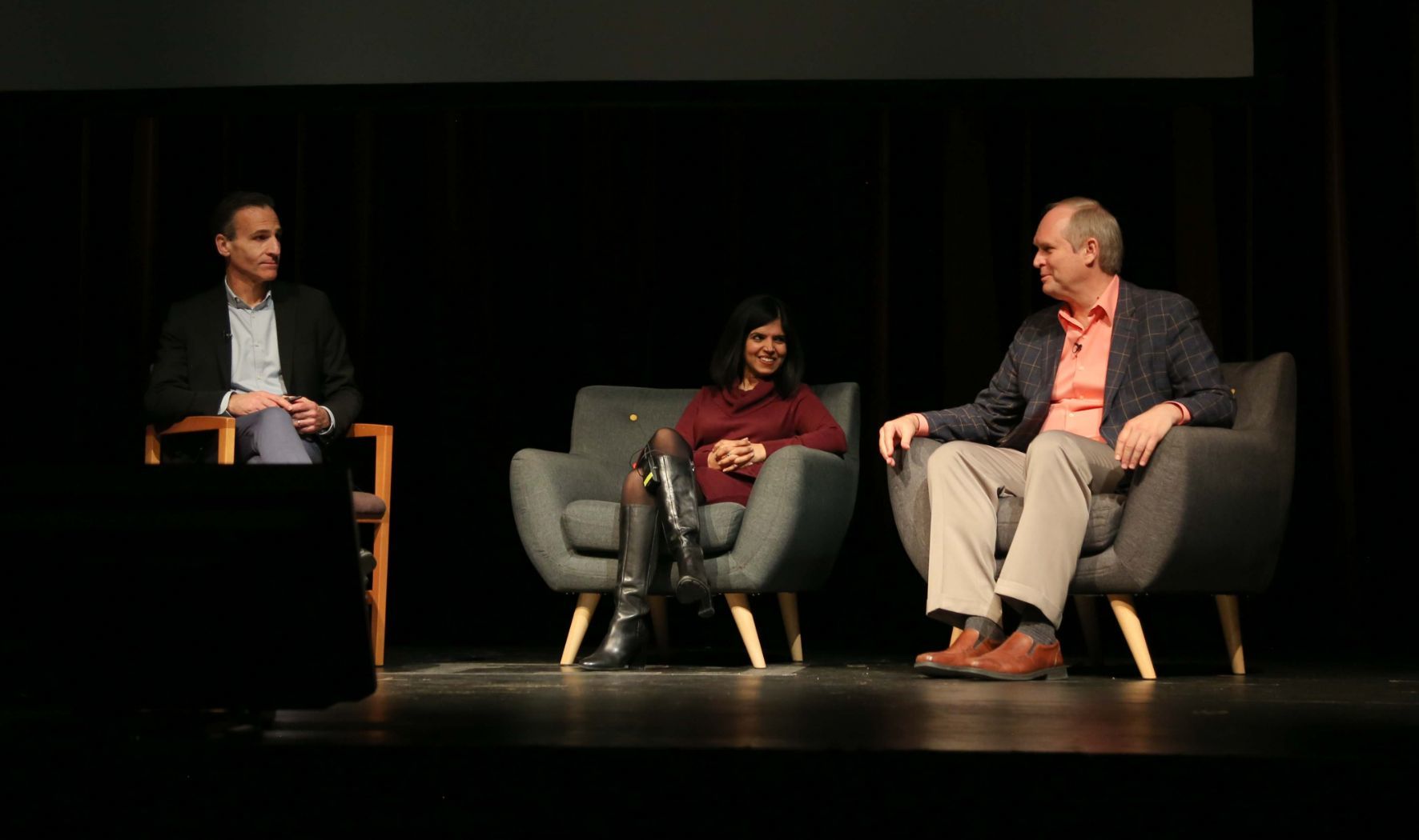 Tom Denari sits with Monica Wadhwa and Robin Hanson onstage during Q&A
